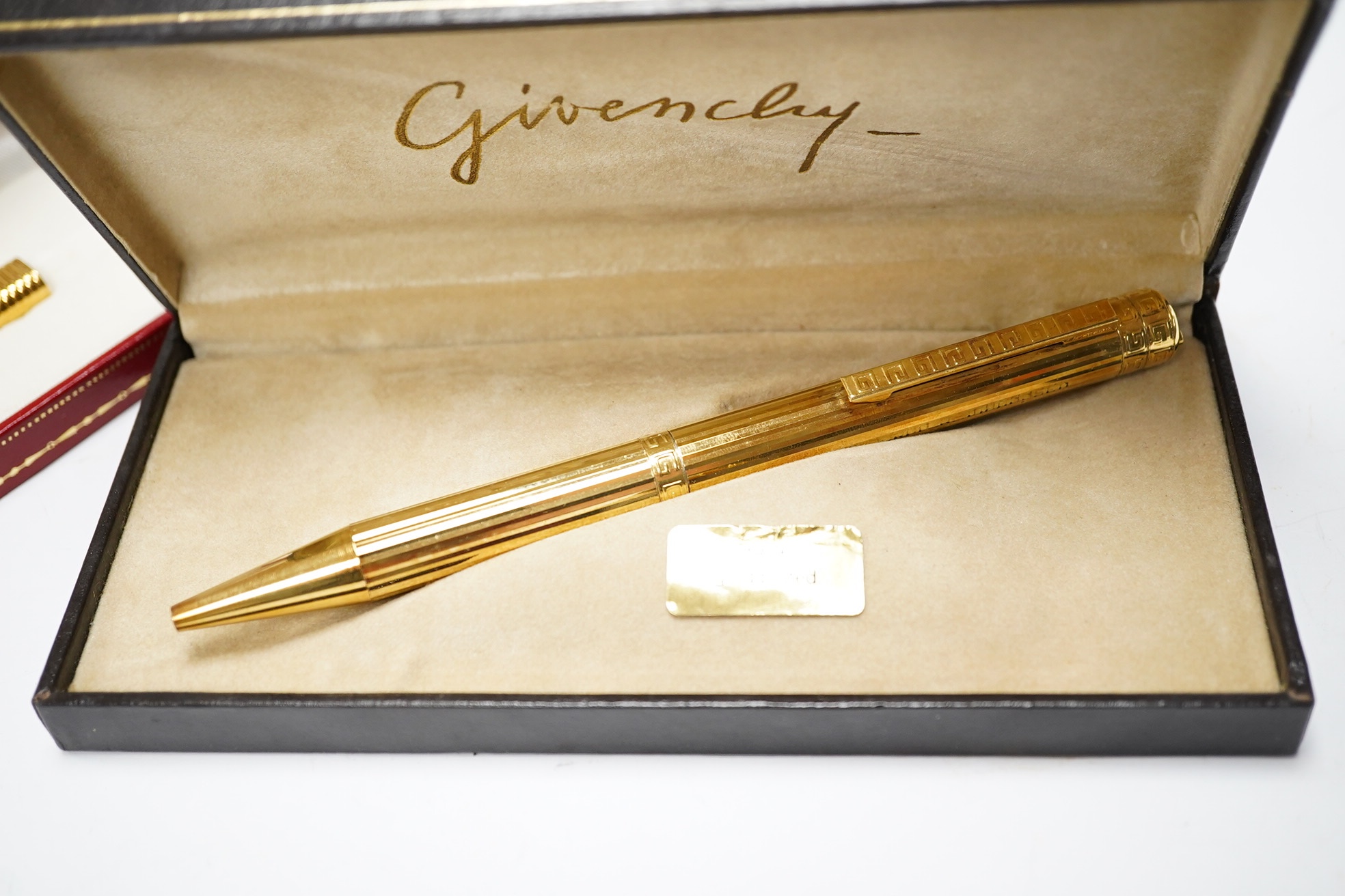 A Cartier gold plated pen and a Givenchy 18ct gold plated pen, both boxed. Cartier pen 13.5cm long. Condition - good, Givenchy box needs attention